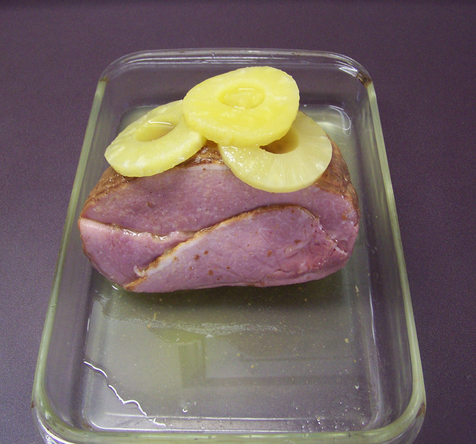 Add pineapple slices to the top of the ham